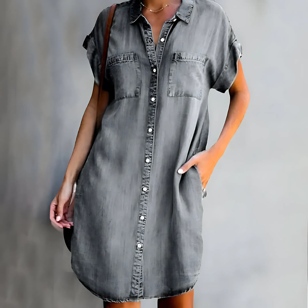 Gray denim dress worn by a person against a gray background