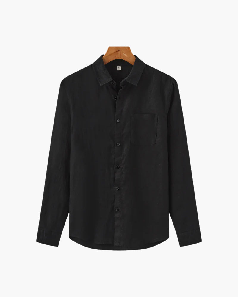 Black shirt on a hanger against a white background