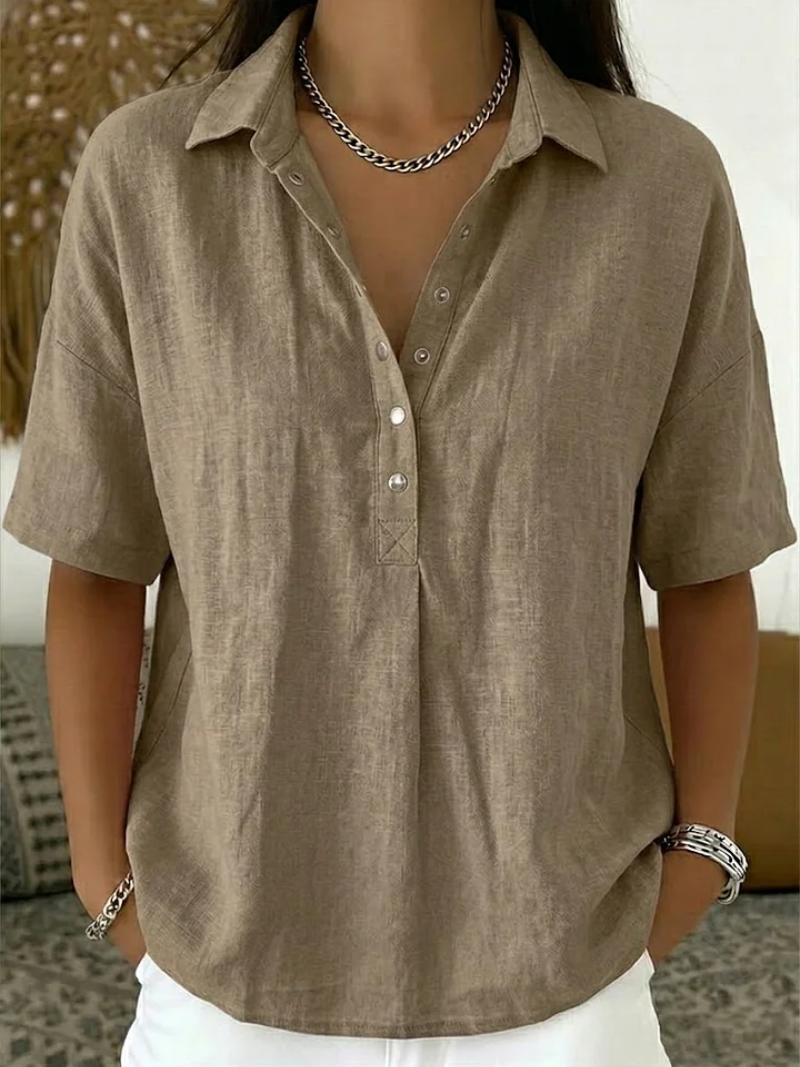 Brown short-sleeve shirt worn by a person with a neutral background