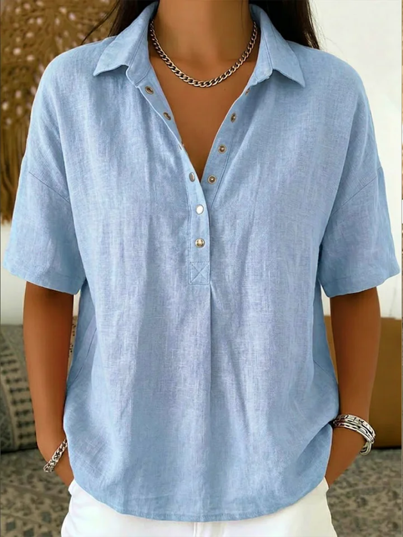 Light blue button-up shirt worn by a person with a neutral background