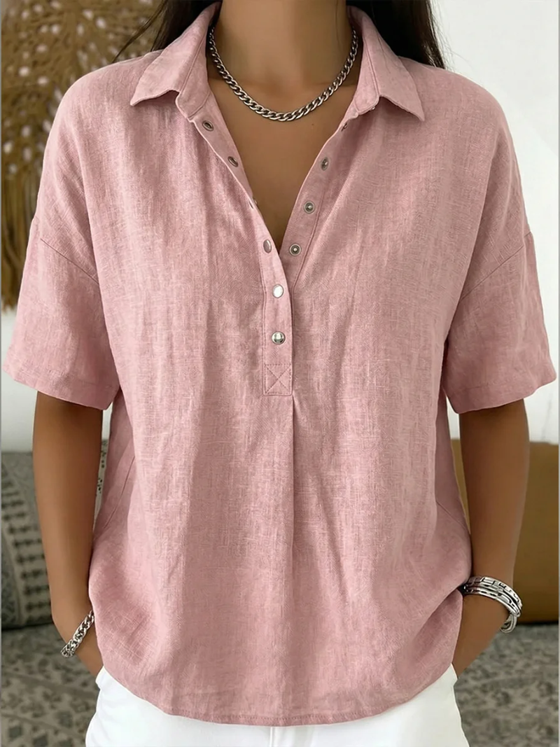 Pink linen shirt worn by a person with a blurred background