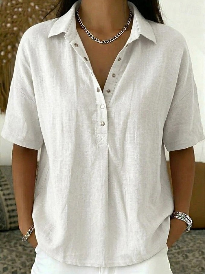 Person wearing a white short-sleeve shirt with a neutral background