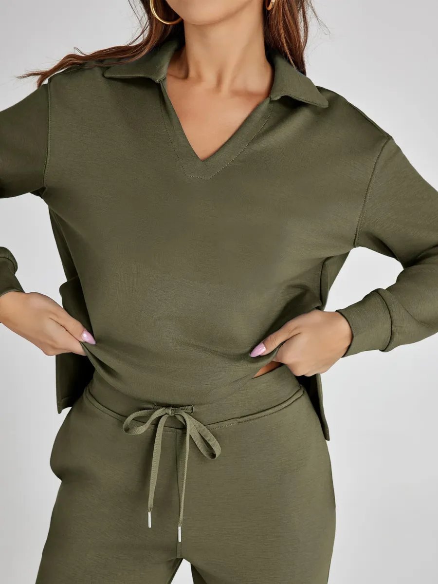Person wearing an olive green outfit with a matching jacket and pants on a plain background