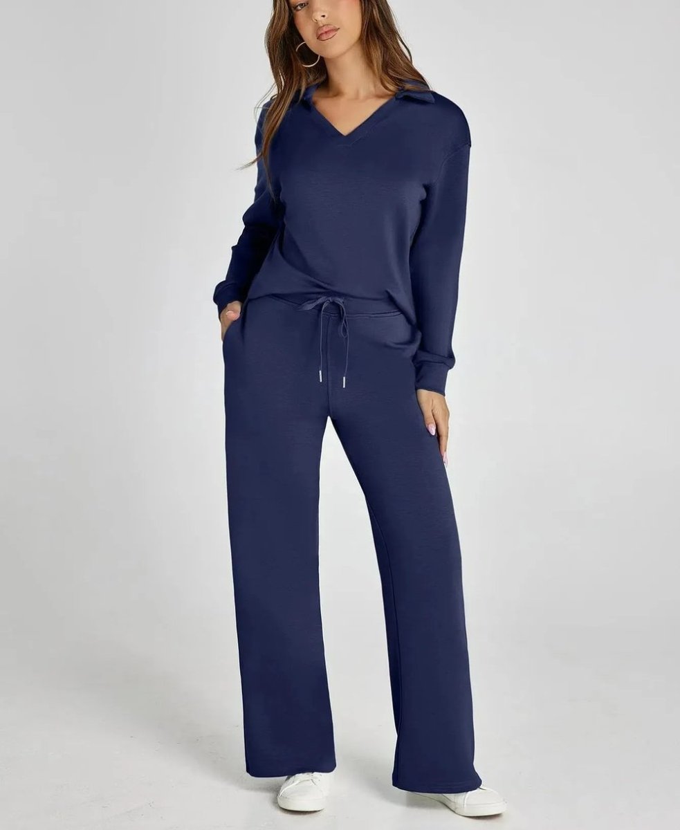 Woman wearing a navy blue tracksuit on a white background