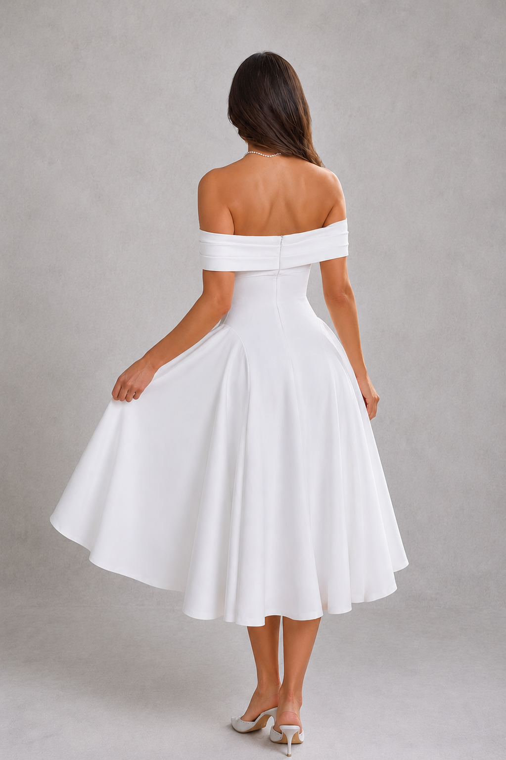 Woman wearing a white off-shoulder dress against a gray background