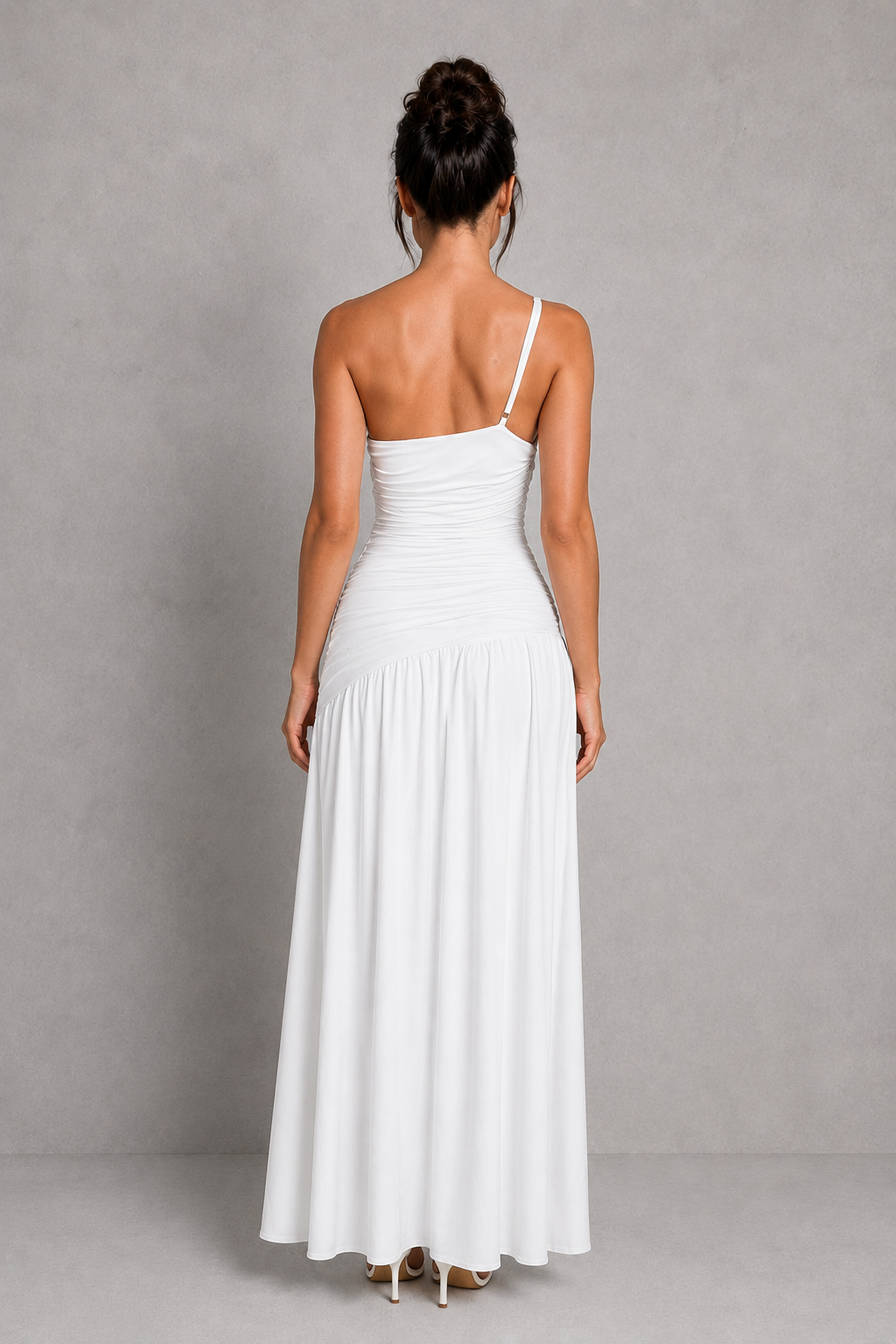 Woman wearing a white dress against a gray background