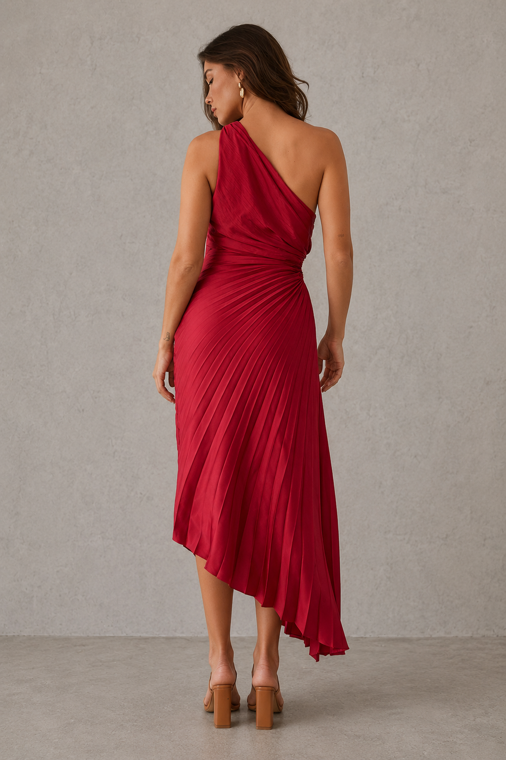 Woman wearing a red one-shoulder dress against a neutral background