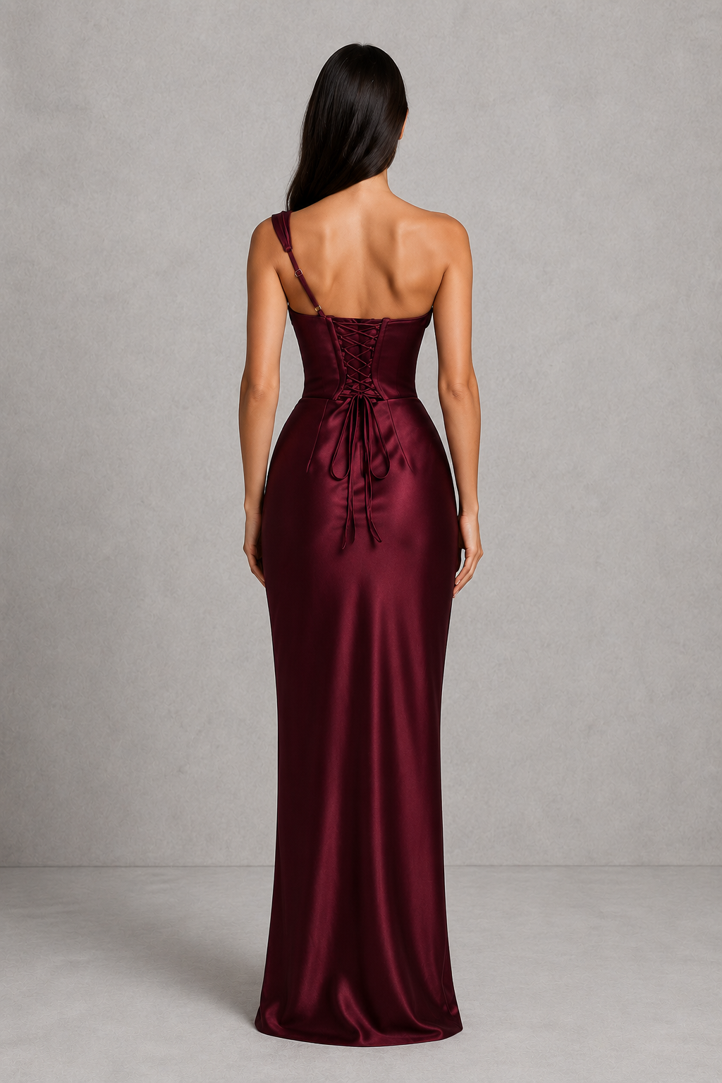 Burgundy satin gown with a tie detail on a gray background