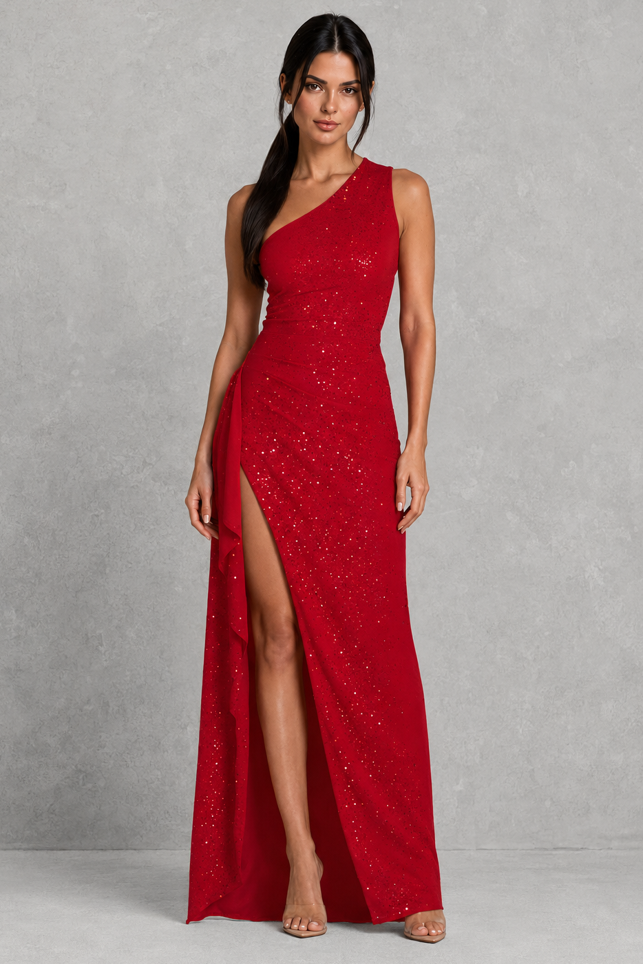 Woman wearing a red one-shoulder dress with a slit on a gray background