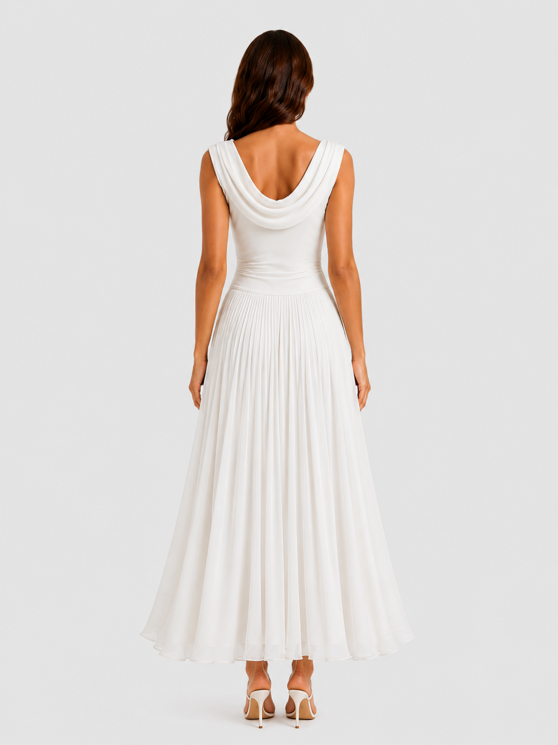 Woman wearing a white sleeveless dress on a plain background
