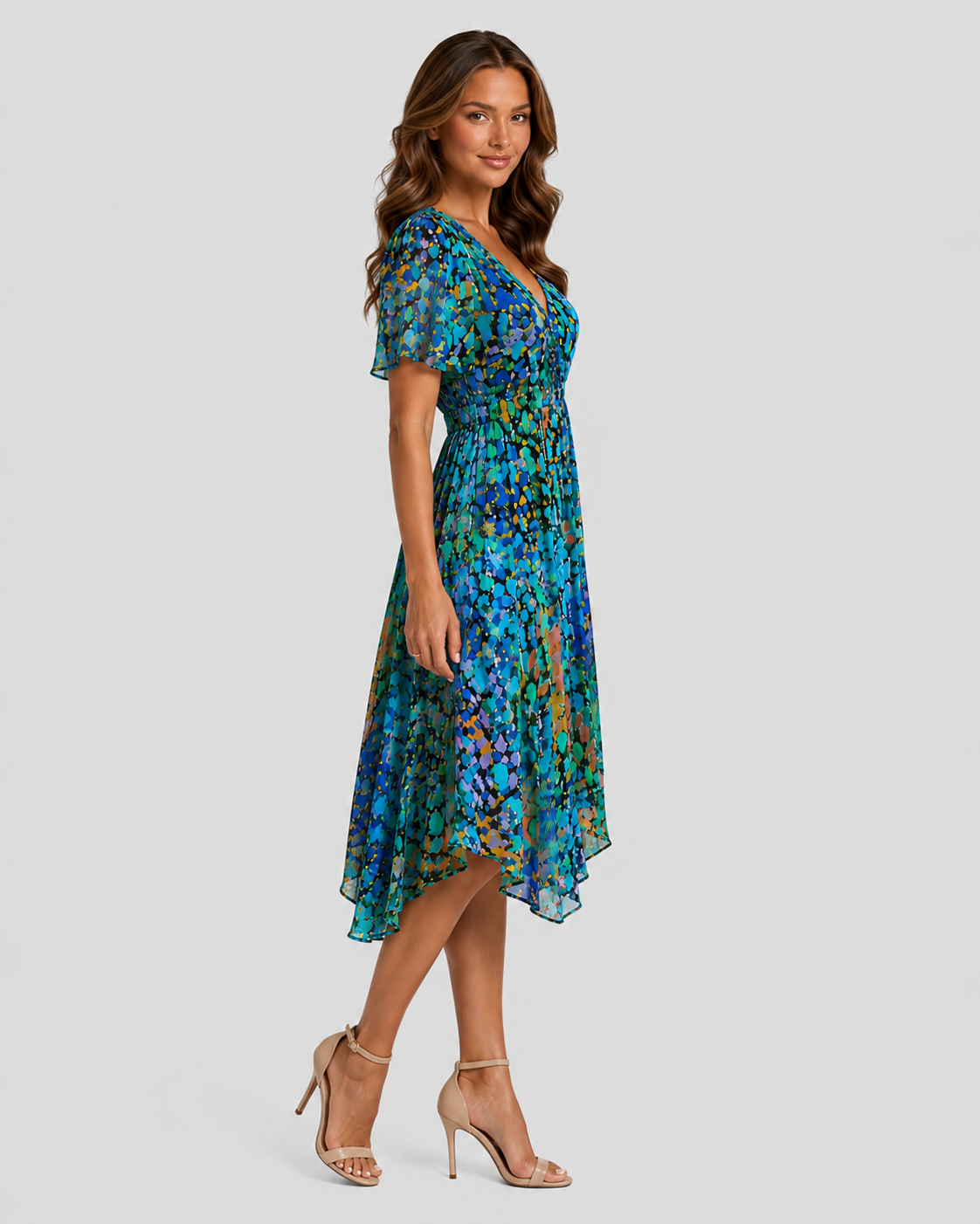 Woman wearing a blue floral dress on a gray background