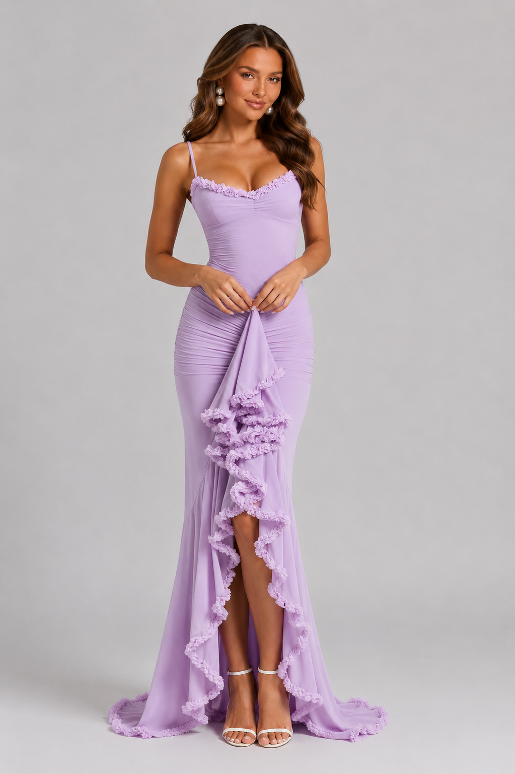 Woman wearing a lavender evening gown with floral details on a gray background
