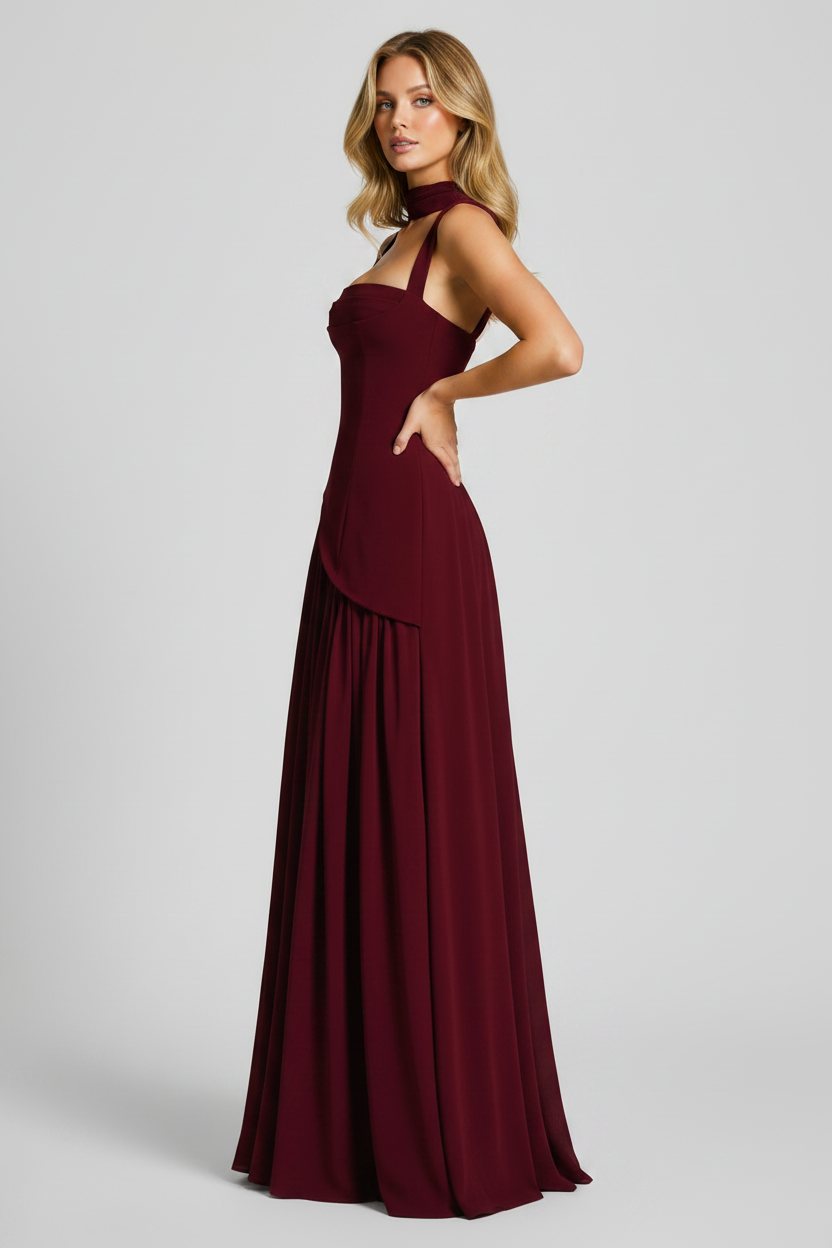 Burgundy evening gown on a model against a plain background