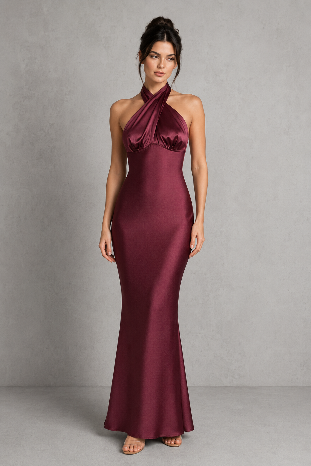 Woman wearing a burgundy evening gown against a gray background
