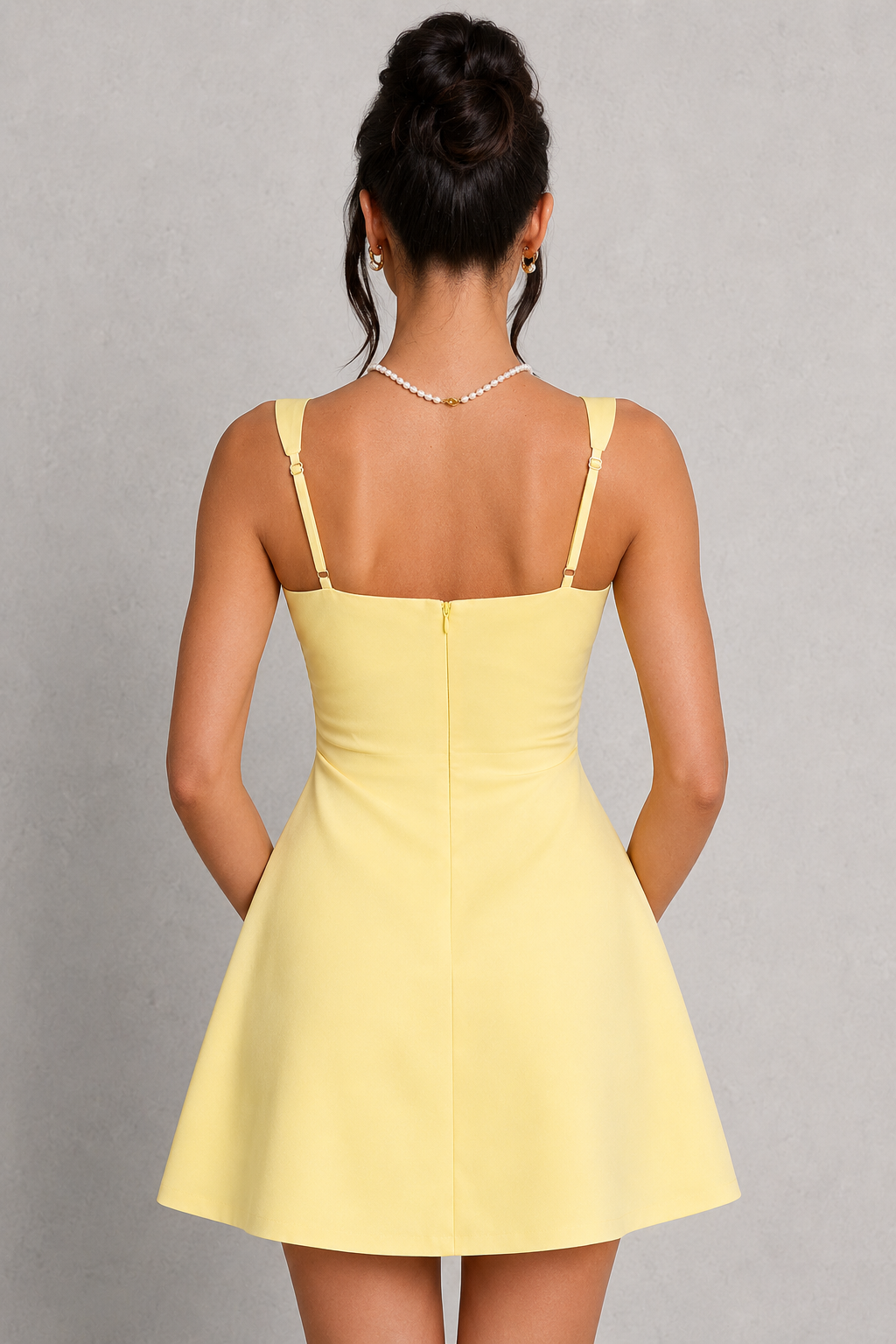 Yellow dress worn by a person on a gray background