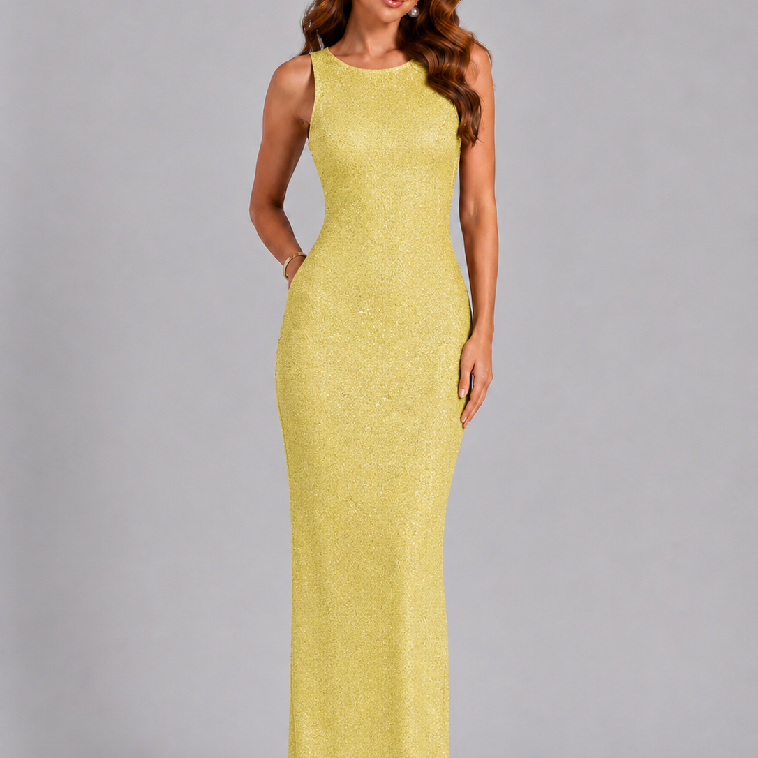 Woman wearing a yellow evening gown against a gray background