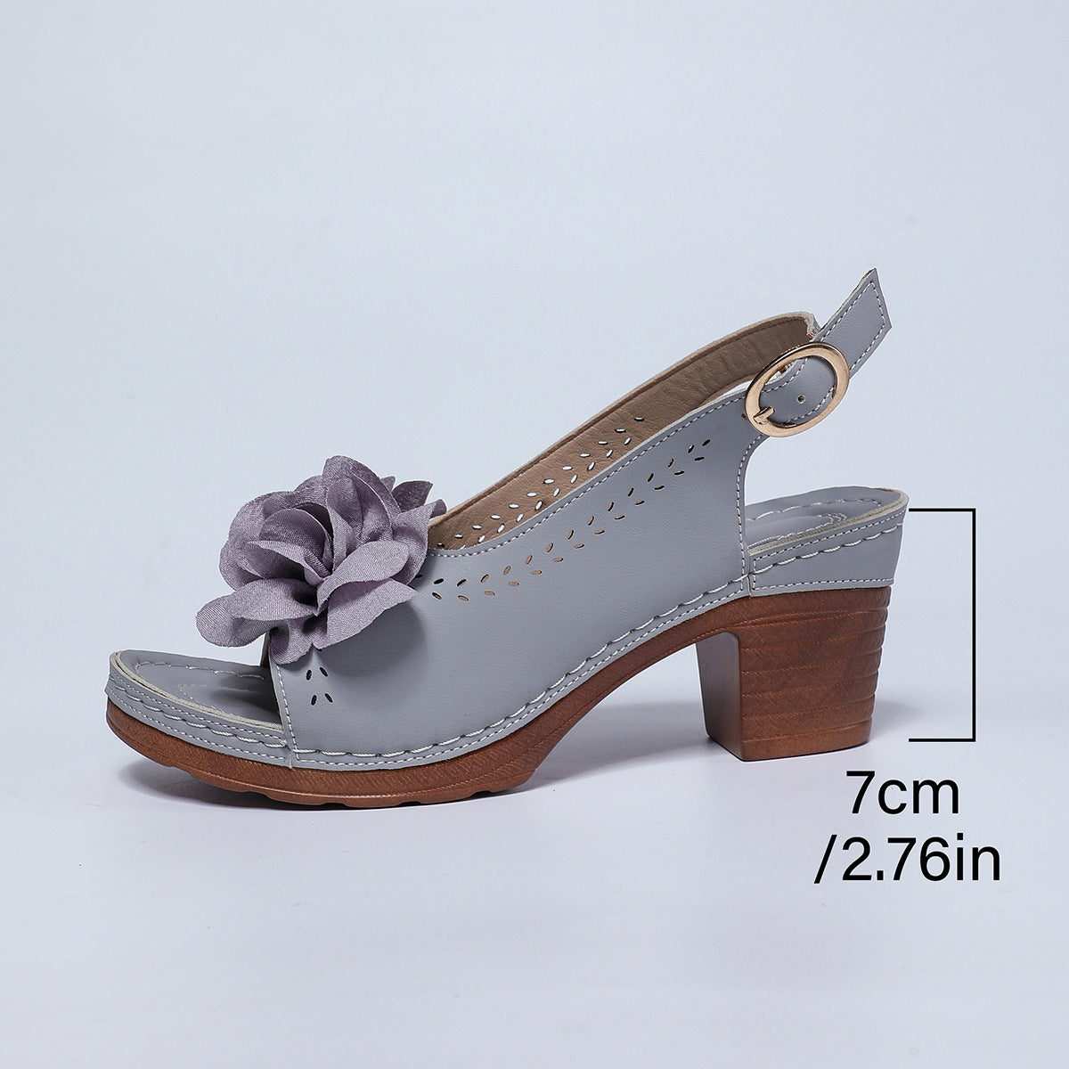 Gray sandal with a flower detail on a light gray background