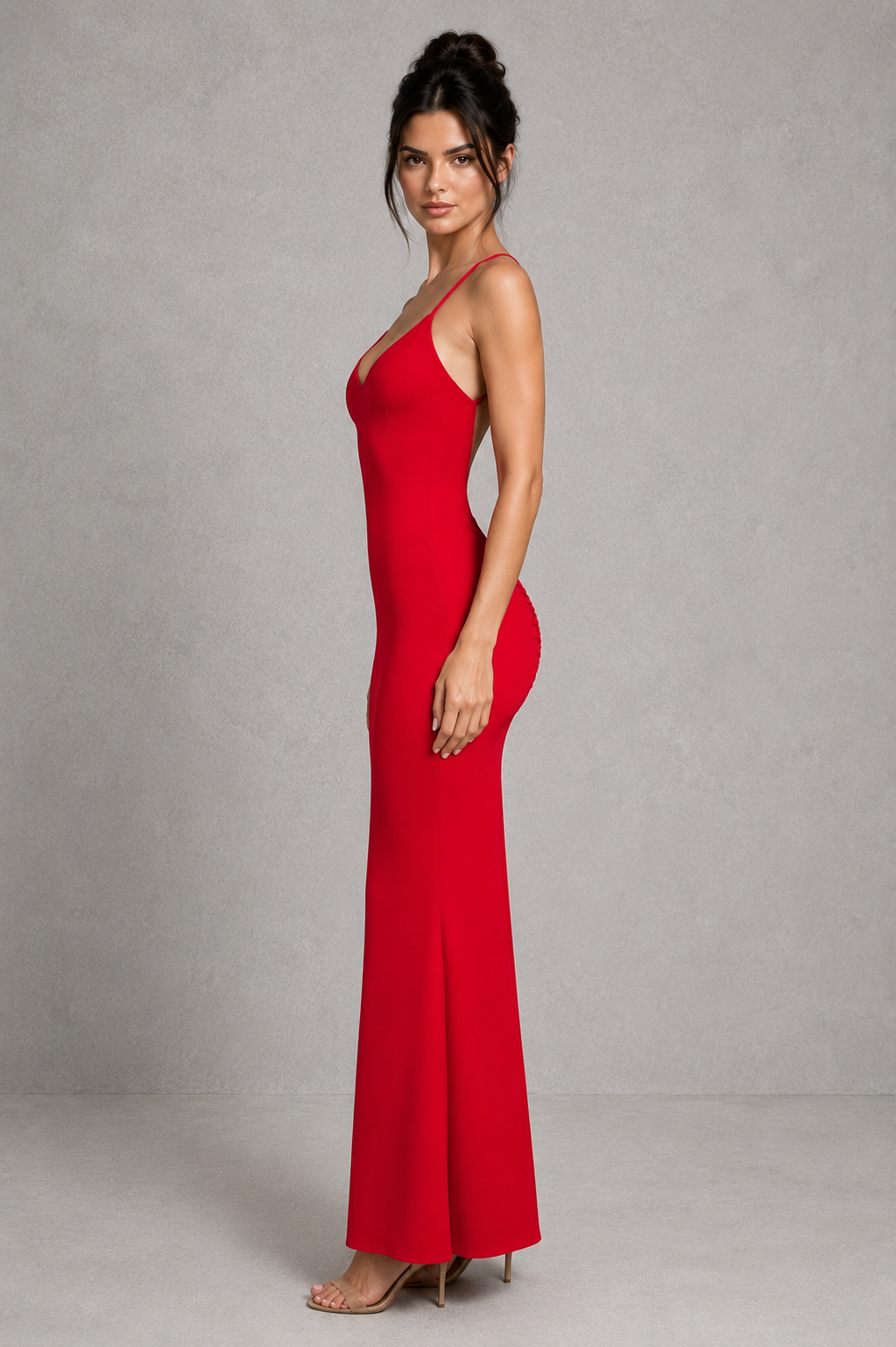 Woman wearing a red evening gown against a gray background