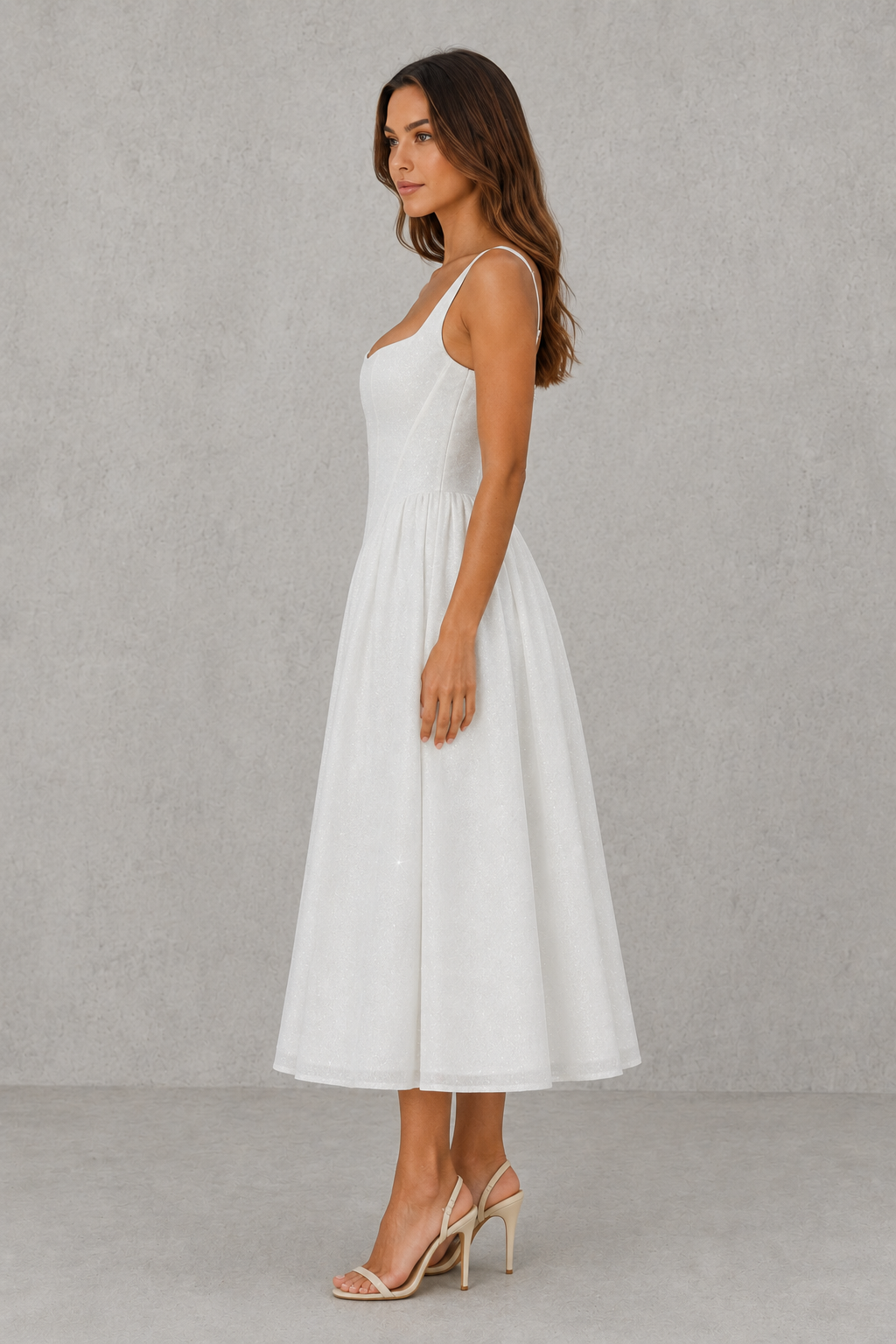 Woman wearing a white dress against a plain background
