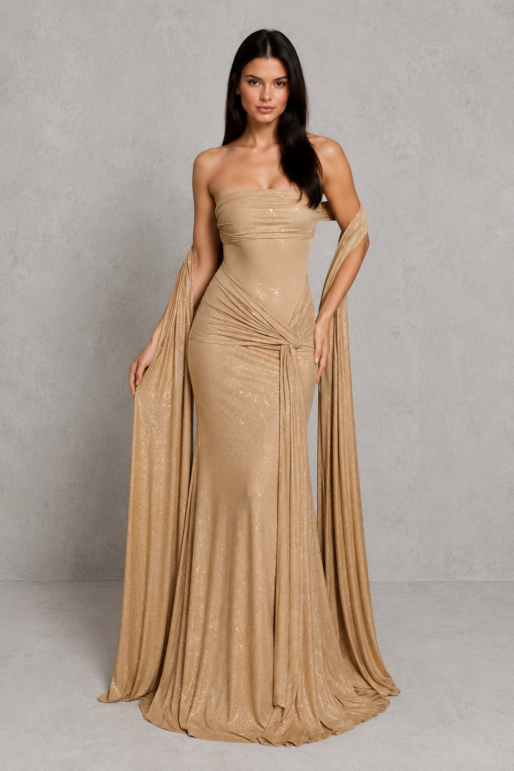 Woman wearing a gold evening gown against a plain background