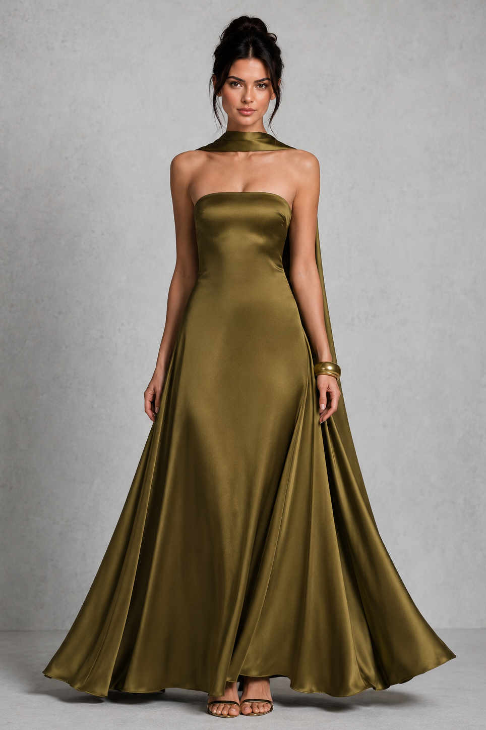 Woman wearing a green strapless gown against a gray background