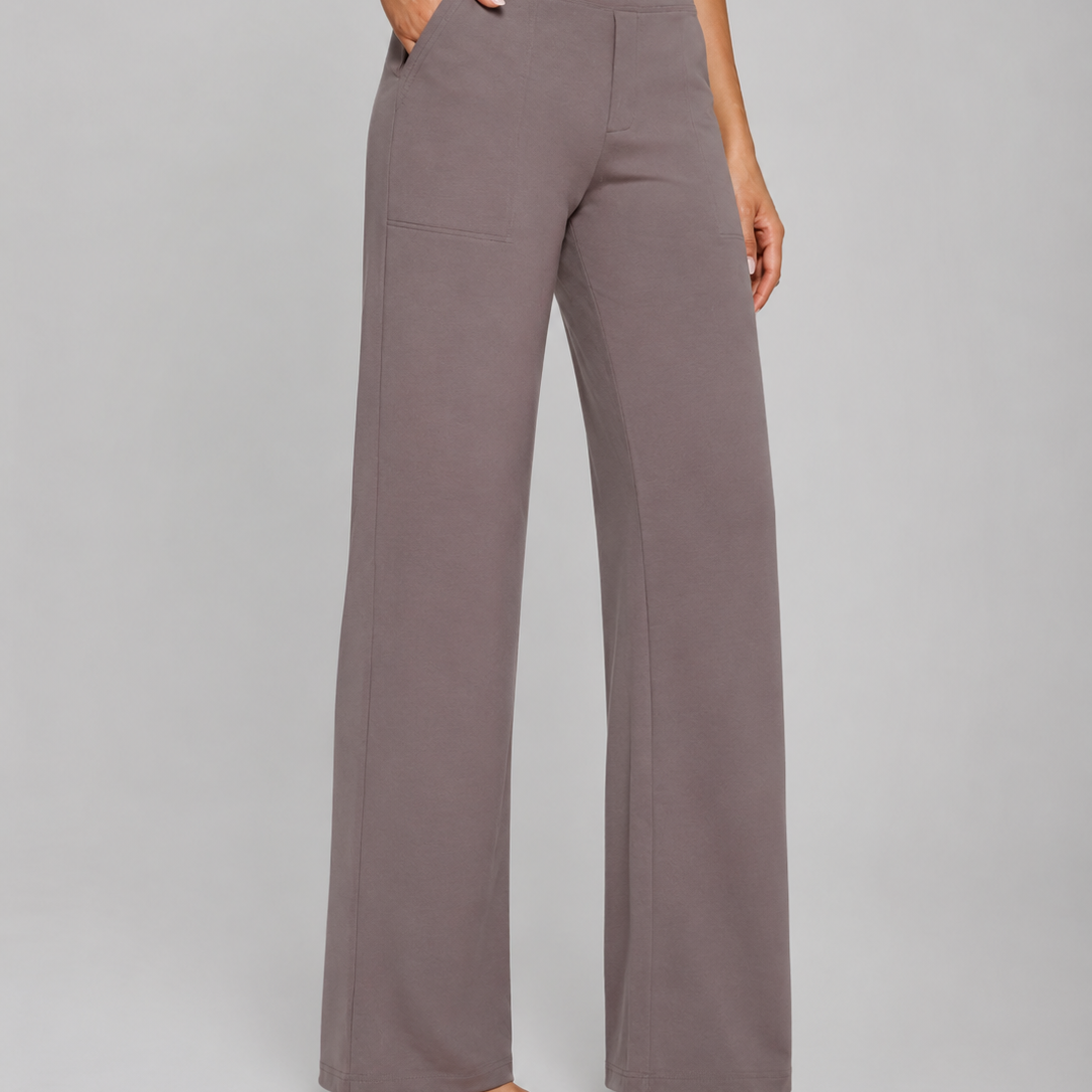 Person wearing gray wide-leg pants on a plain background