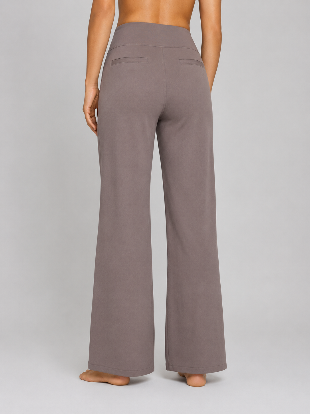Brown wide-leg pants worn by a person on a gray background