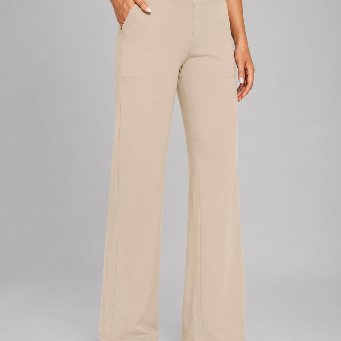 Beige high-waisted pants worn by a person on a gray background