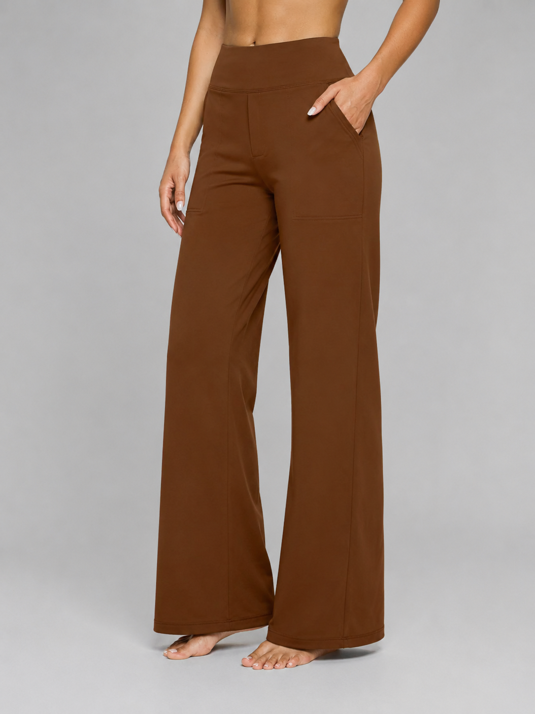 Brown wide-leg pants worn by a person on a gray background