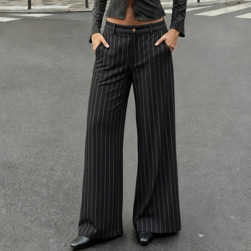 Person wearing black pinstripe pants on a gray street