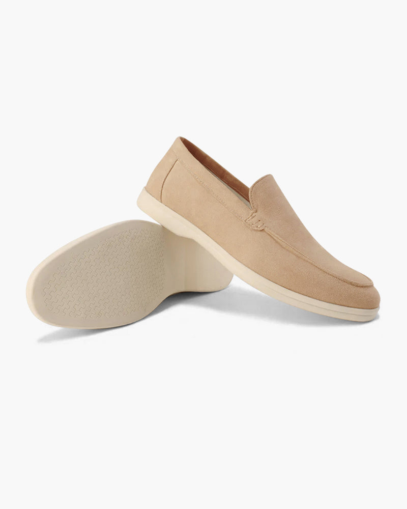 Pair of beige loafers on a white background
