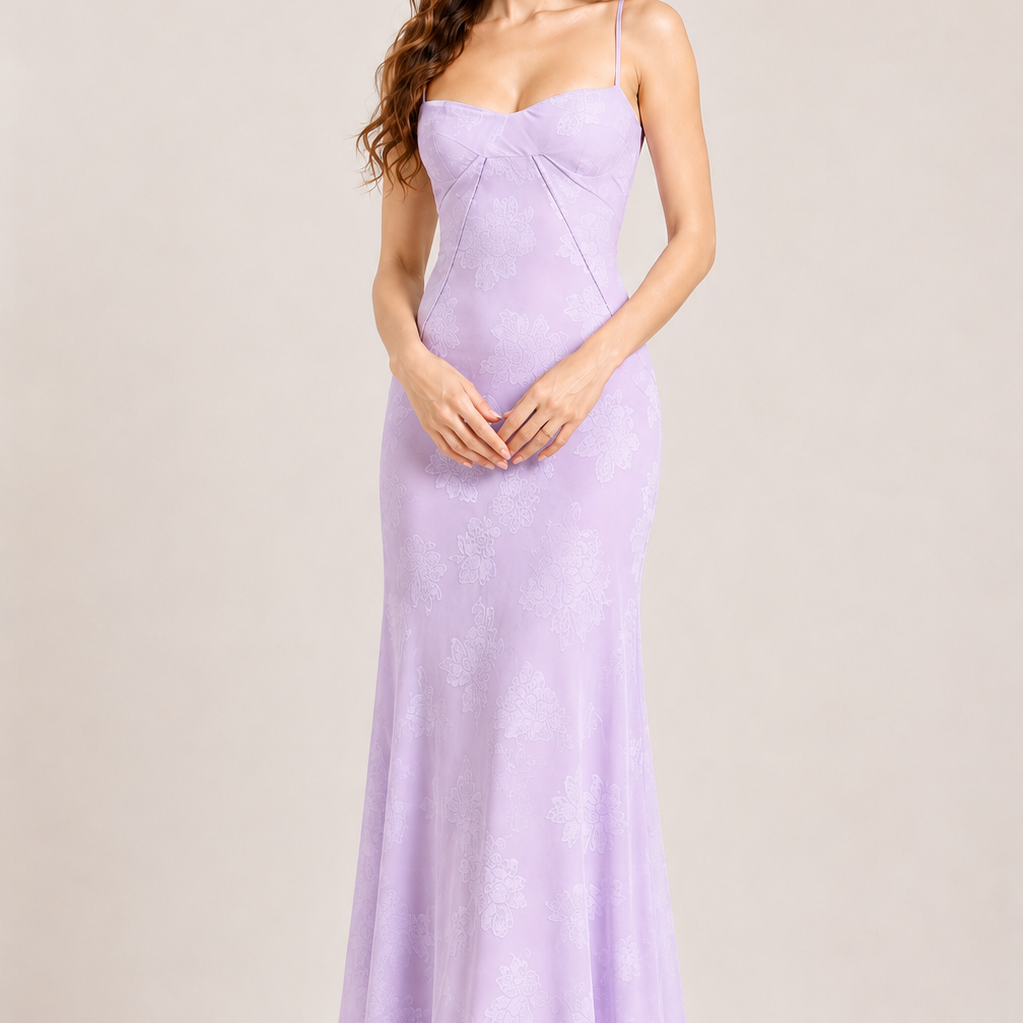 Woman wearing a lavender evening gown against a plain background