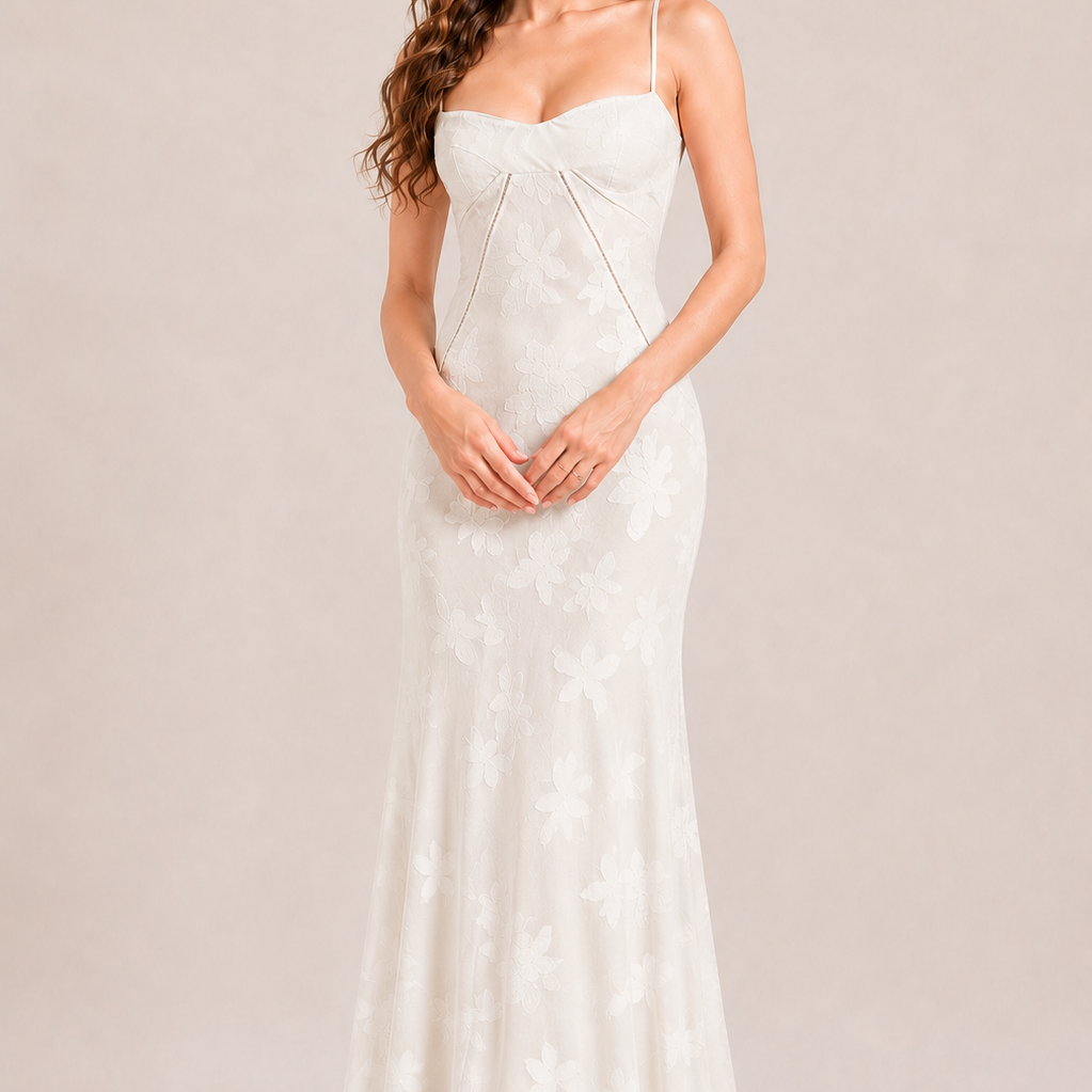 Woman wearing a white strapless dress against a plain background