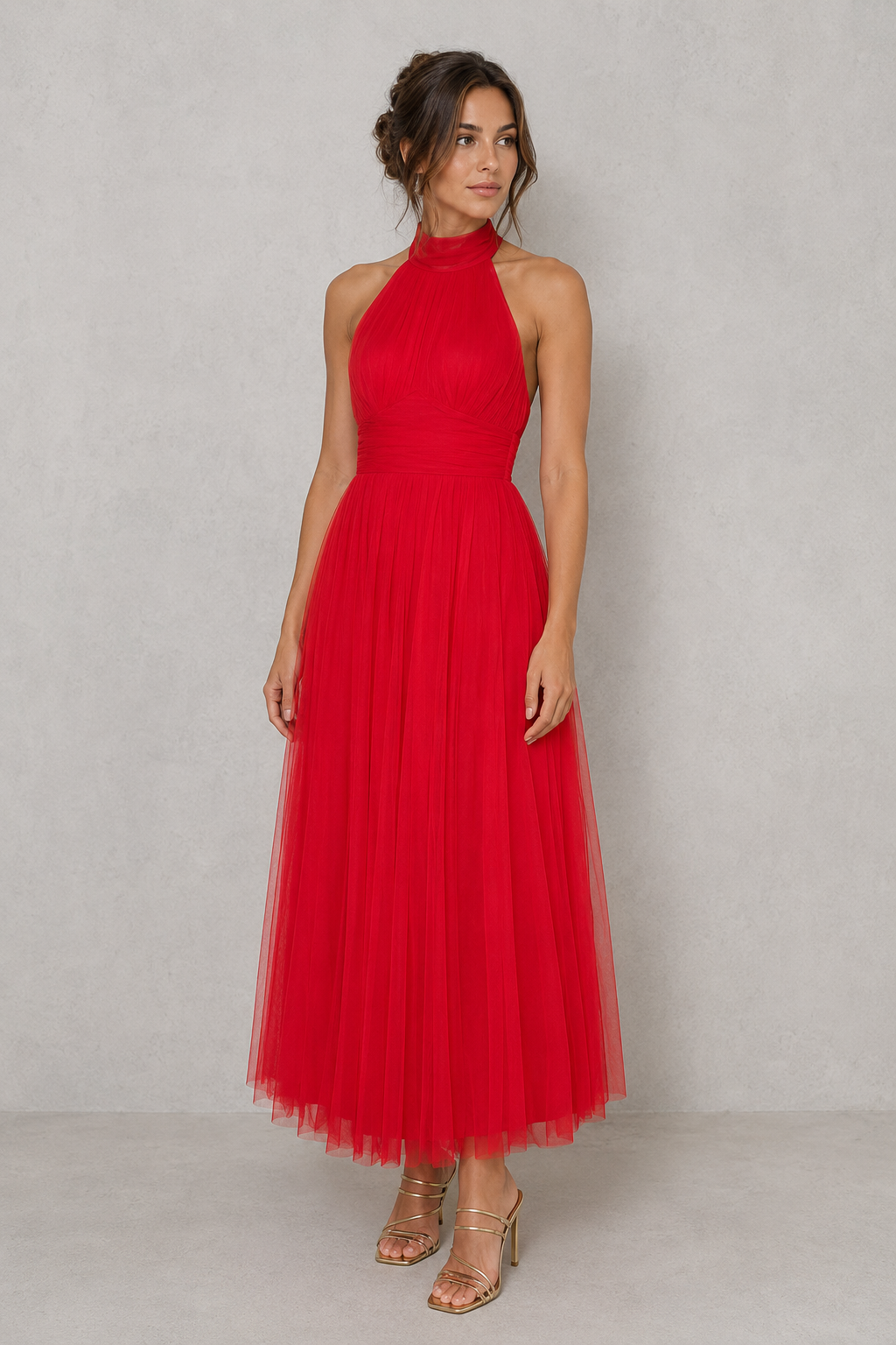Woman wearing a red halter neck dress against a plain background