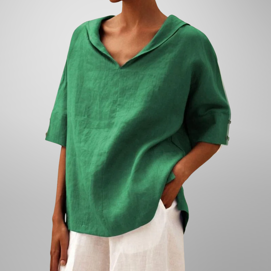 Person wearing a green shirt with a plain background