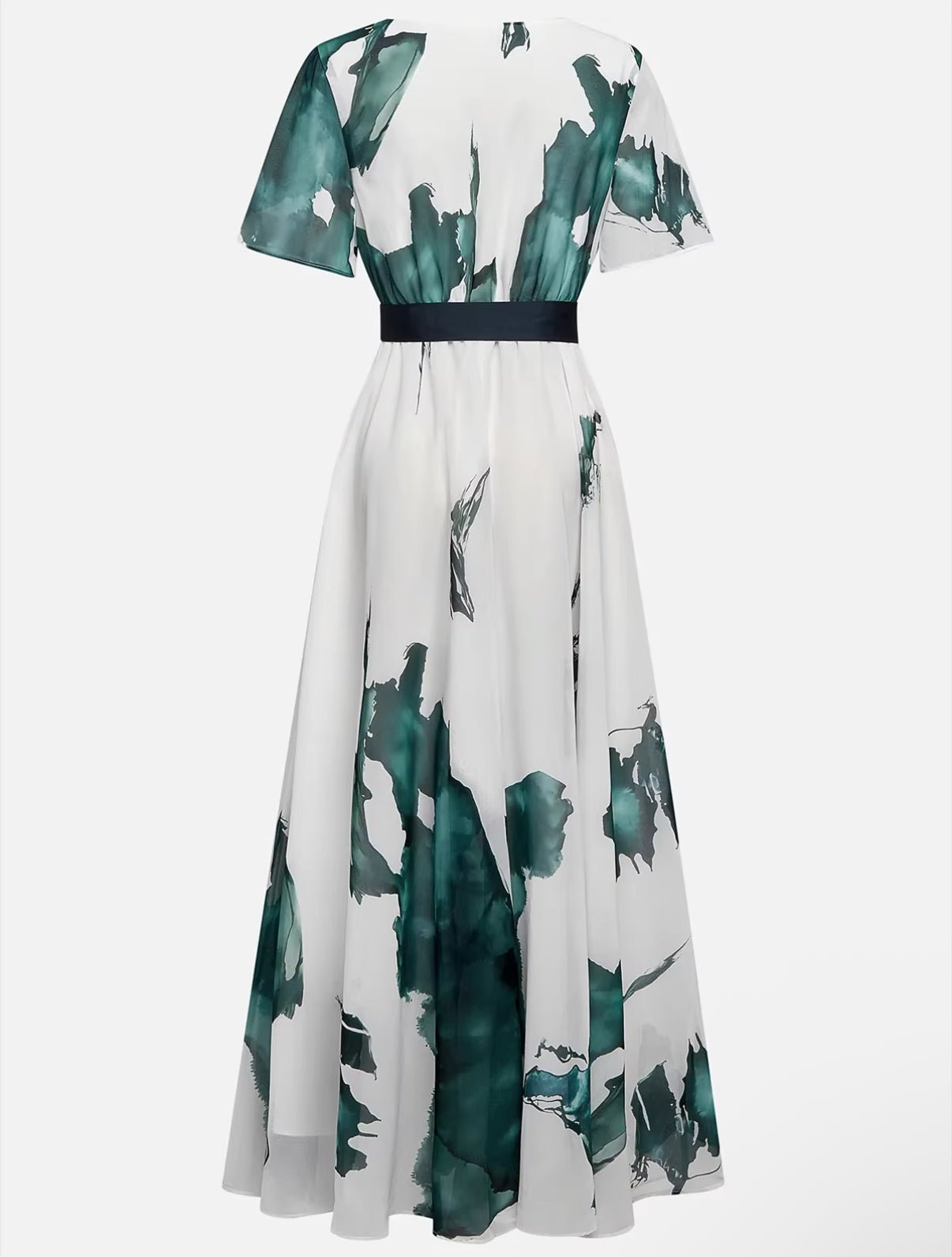 White dress with green floral pattern on a white background