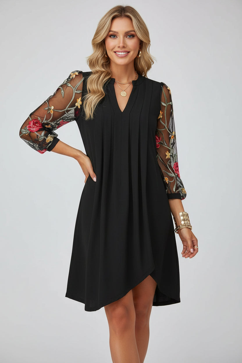 Black dress with floral sleeves against a white background