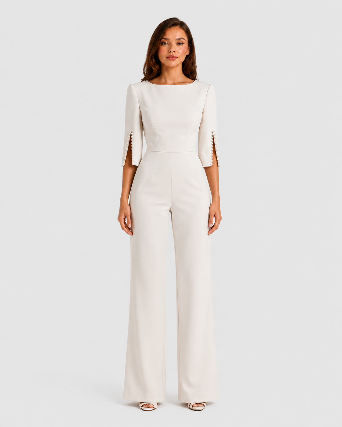 Woman wearing a white jumpsuit on a plain background