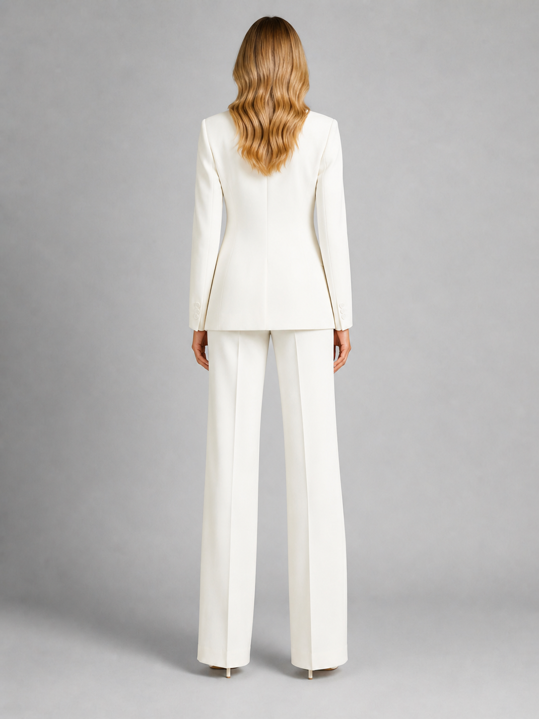 Woman wearing a white suit on a gray background