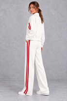 Women's white zip-up tracksuit set with red side stripes – back view