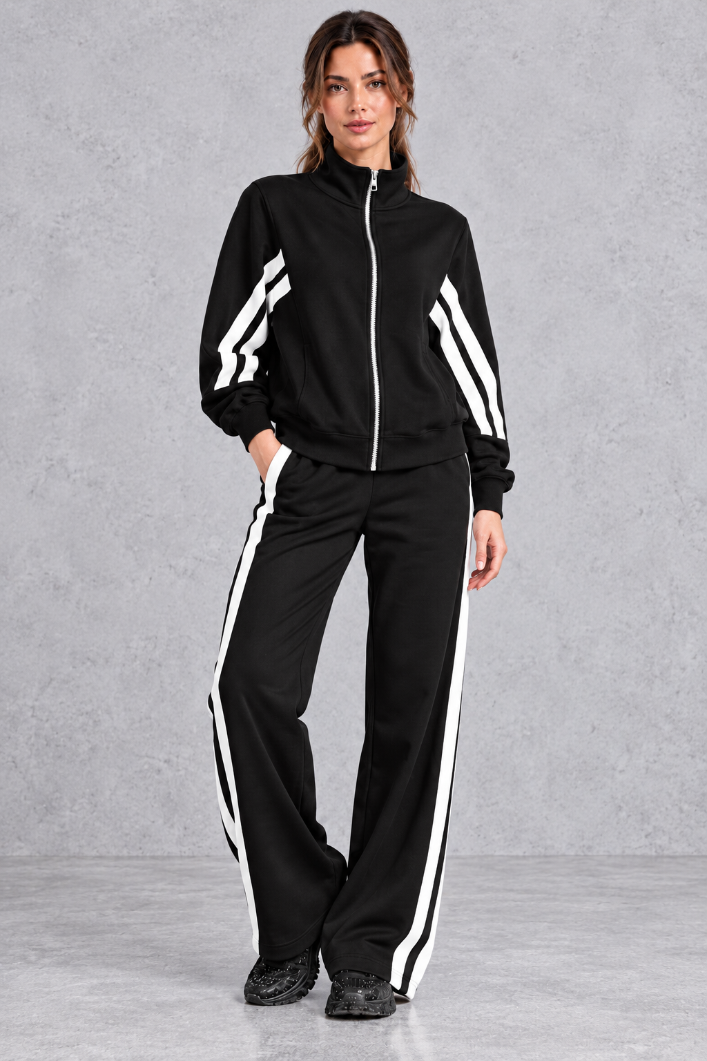 Women's black zip-up tracksuit set with white side stripes – front view
