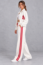 Women's white zip-up tracksuit set with wide leg striped joggers – side view