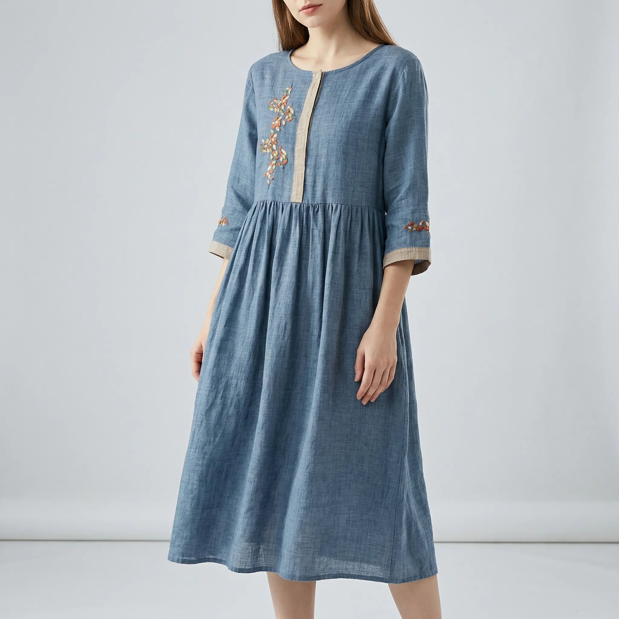 Blue dress with embroidery on a plain background