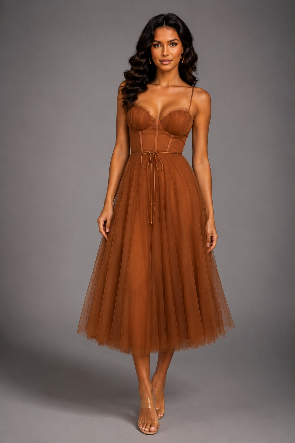 Woman wearing a brown dress against a gray background
