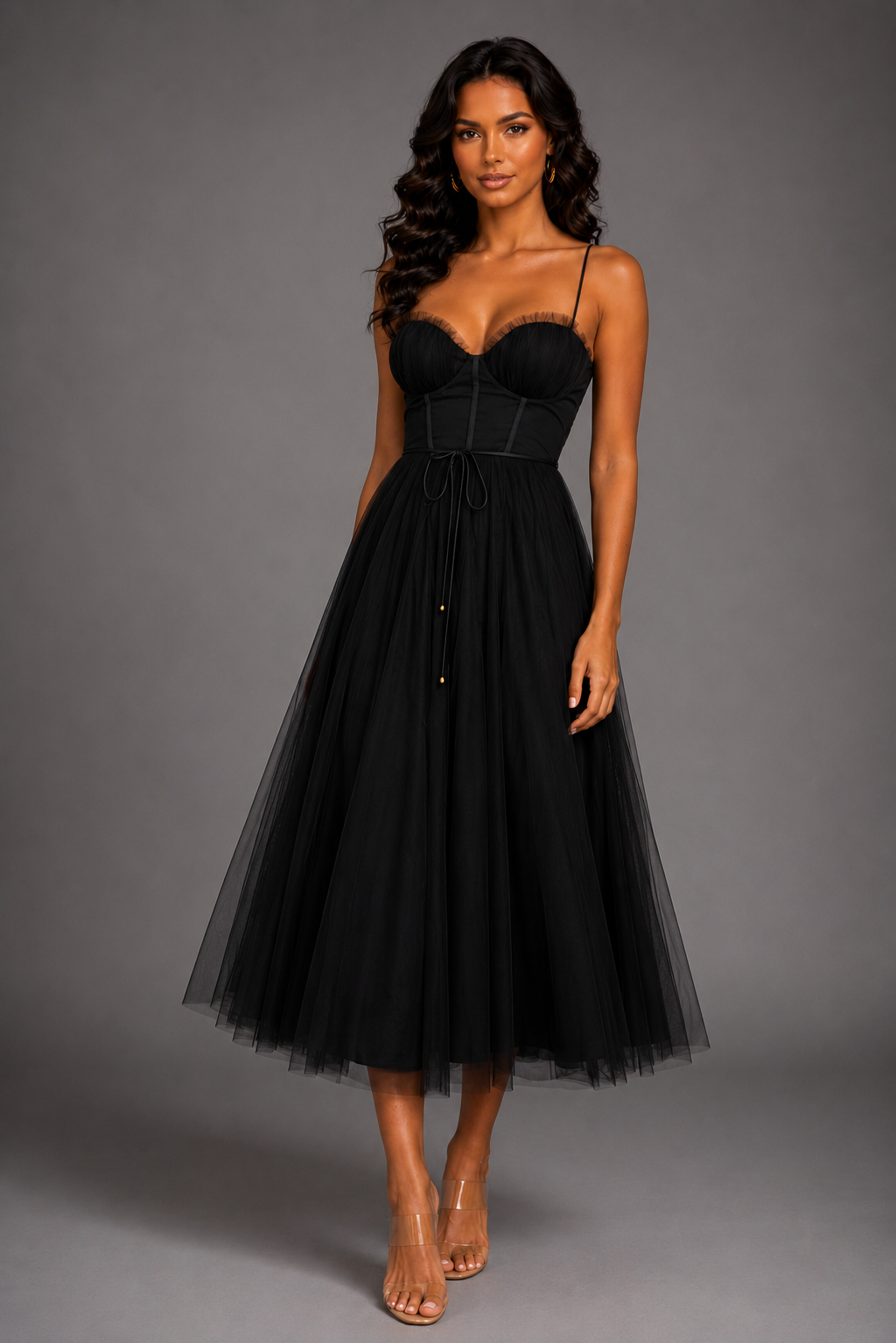 Woman wearing a black dress against a gray background