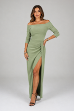 Woman wearing a green off-shoulder dress with a slit on a white background