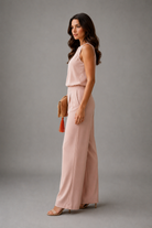 Woman wearing a pink outfit with a gray background