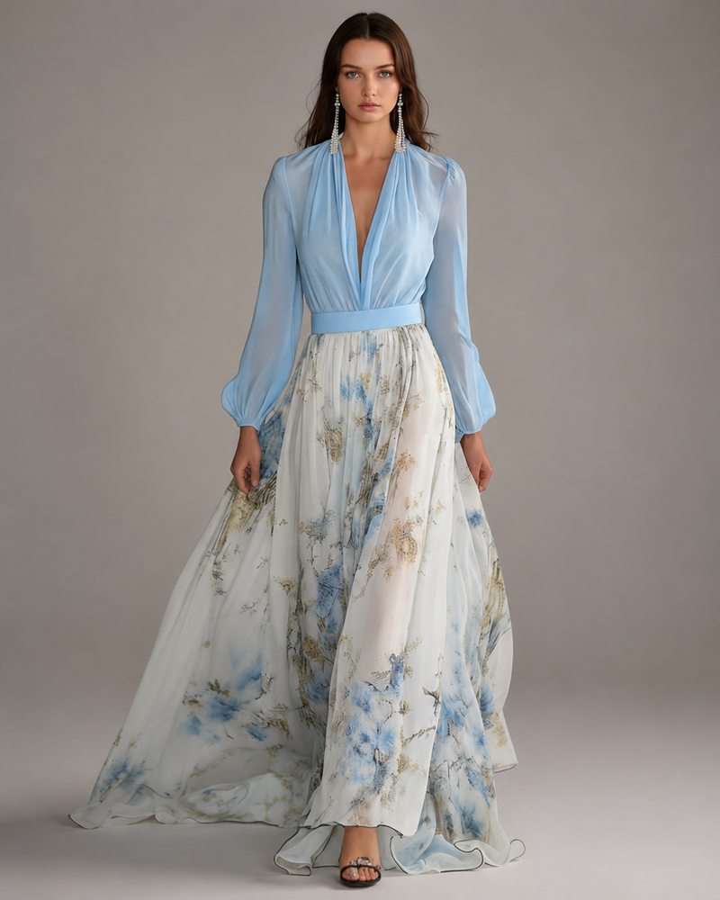 Woman wearing a light blue blouse and floral skirt on a gray background