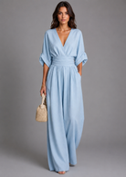 Woman wearing a light blue dress with a plain background