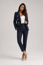 Woman wearing a navy suit with a white top on a light gray background